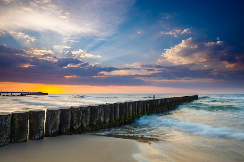 Sunset on the beach with breakwater, long time exposure